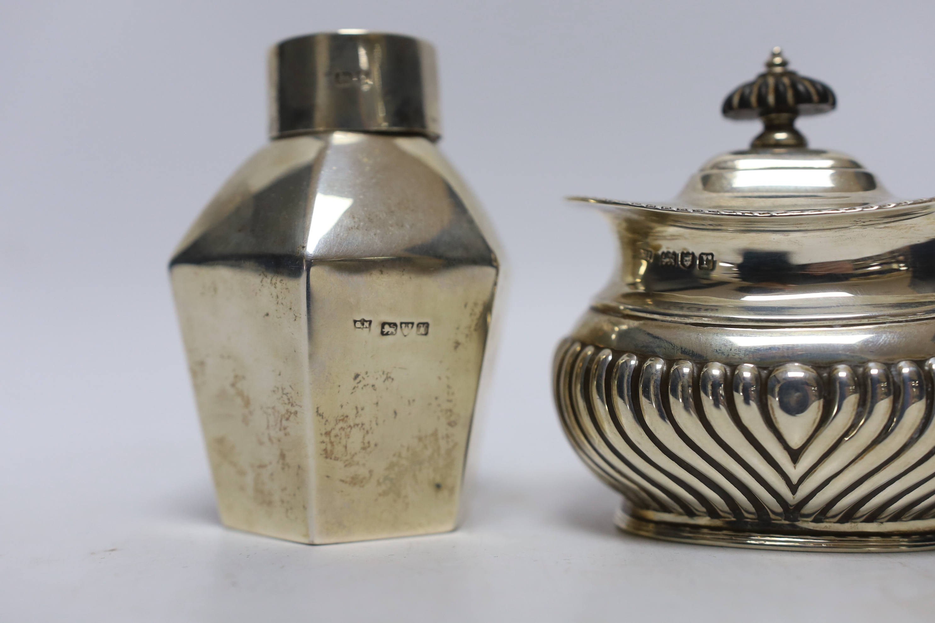 An Edwardian silver hexagonal tea caddy, by Nathan & Hayes, Chester, 1908, 97mm and one other demi-fluted silver tea caddy, George Howson, London, 1912.